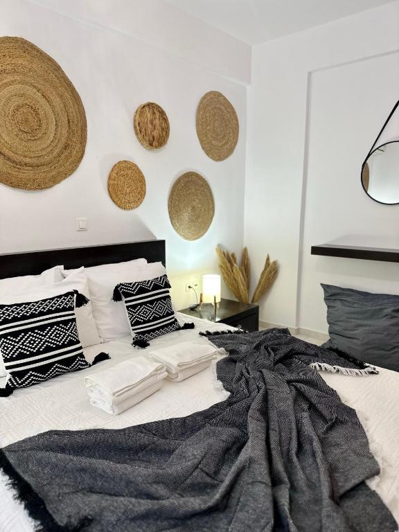 a bedroom with a black and white bed with pillows at Mylos Ηome in Ierapetra