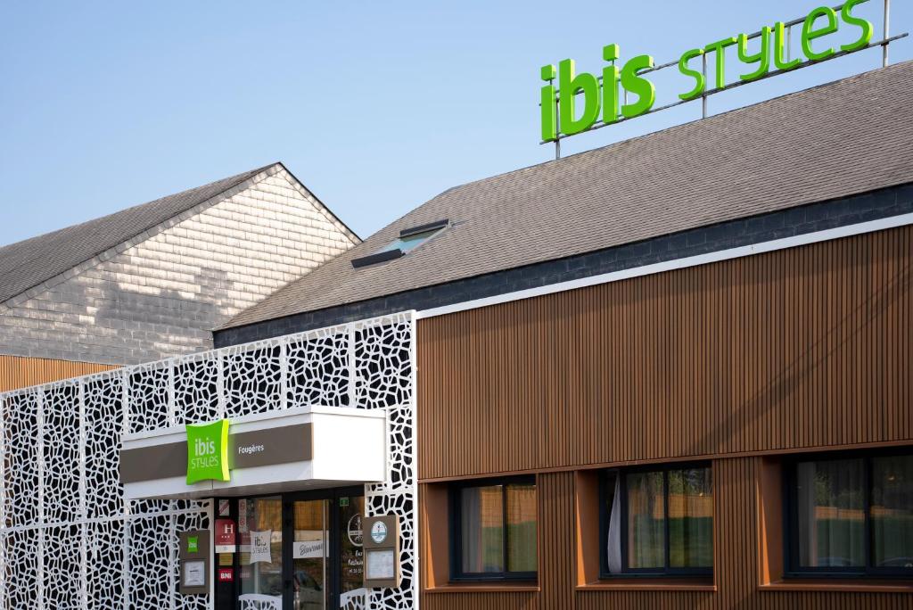 un magasin avec un panneau sur son côté dans l'établissement ibis Styles Fougeres, à Beaucé