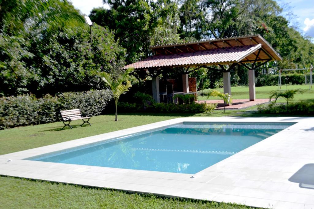 a swimming pool in a yard with a gazebo at Finca El Arrullo in Puerto Espejo