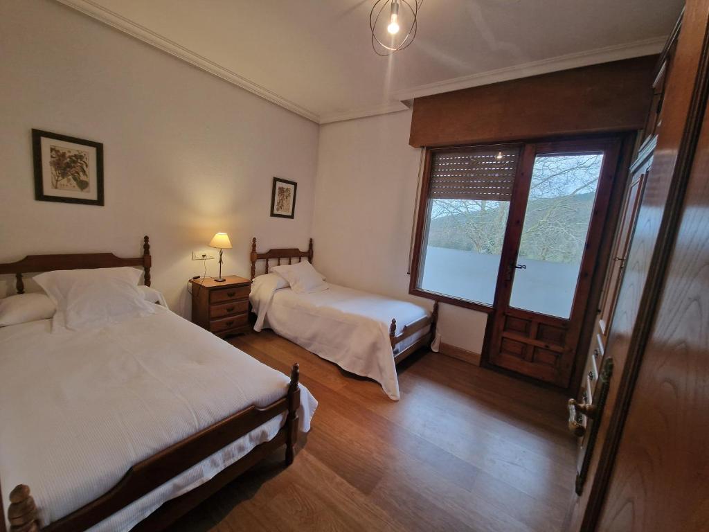 Postel nebo postele na pokoji v ubytování Hostal Lizuniaga