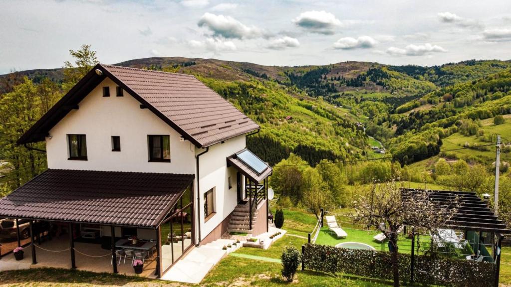 a house with a view of the mountains at Pensiunea K9 in Răchiţele