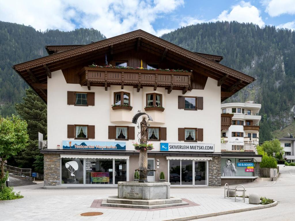 a building with a fountain in front of it at Haus Eberharter in Mayrhofen
