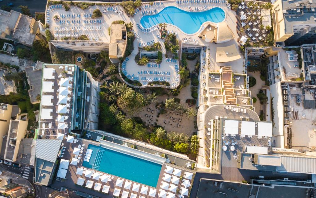 an aerial view of a resort with a swimming pool at InterContinental Malta, an IHG Hotel in St Julian's