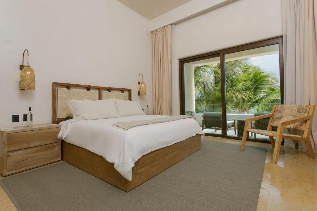 a bedroom with a bed and a view of a patio at 8 Bedroom Luxury Villa with Private Chef Included in Tulum