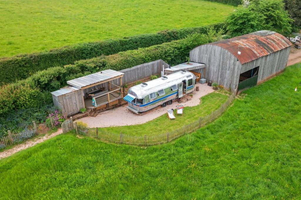 an aerial view of a truck parked next to a barn at Airstream, Devon Hideaways in Kenton