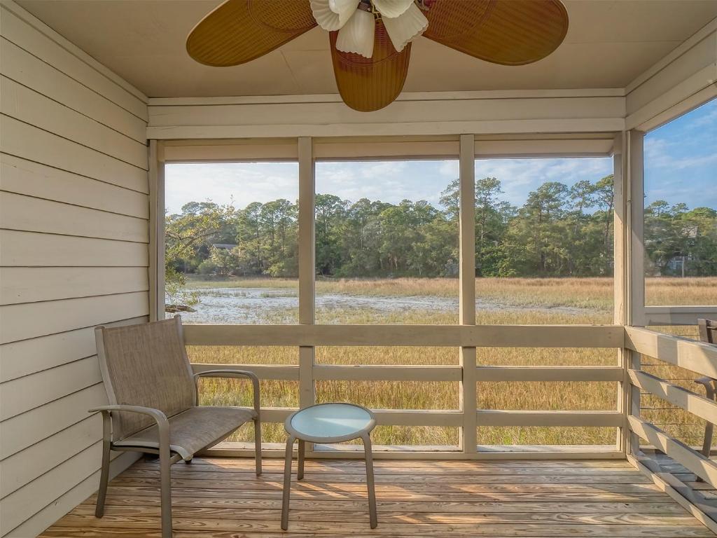 a porch with a chair and a ceiling fan at 1248 Creekwatch Villa in Seabrook Island