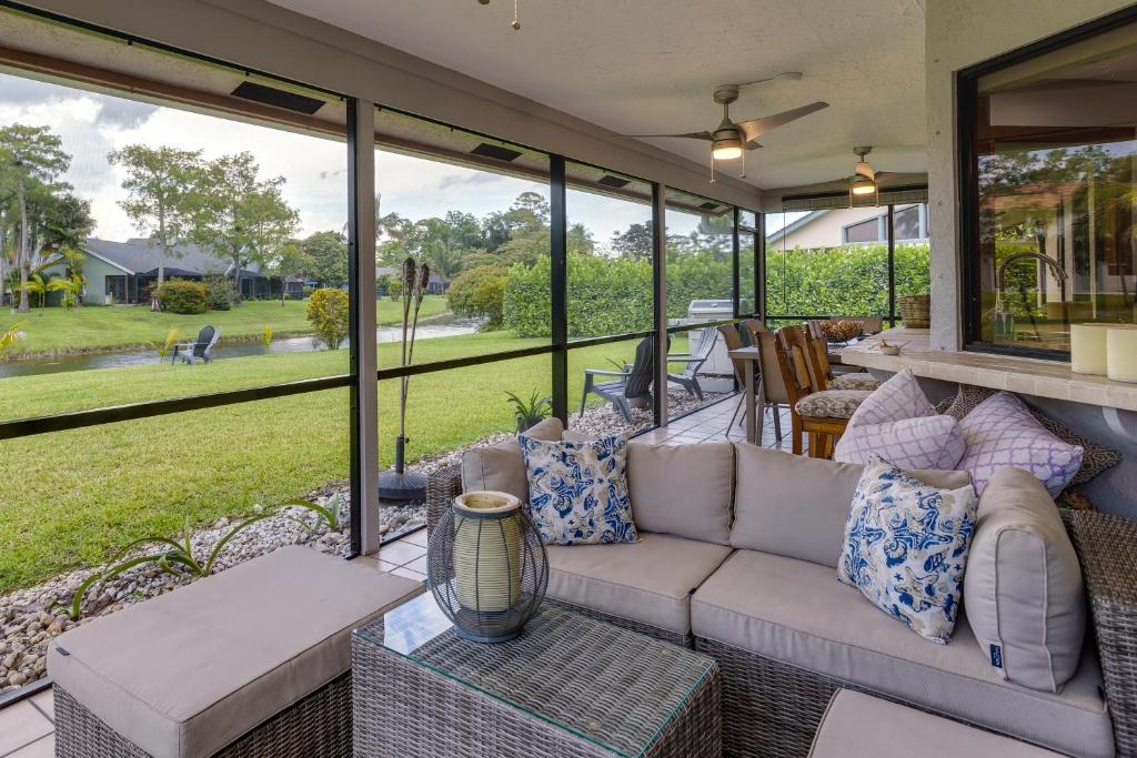 a screened in porch with a couch and a table at Pet-Friendly Wellington Vacation Rental on Canal! in Wellington