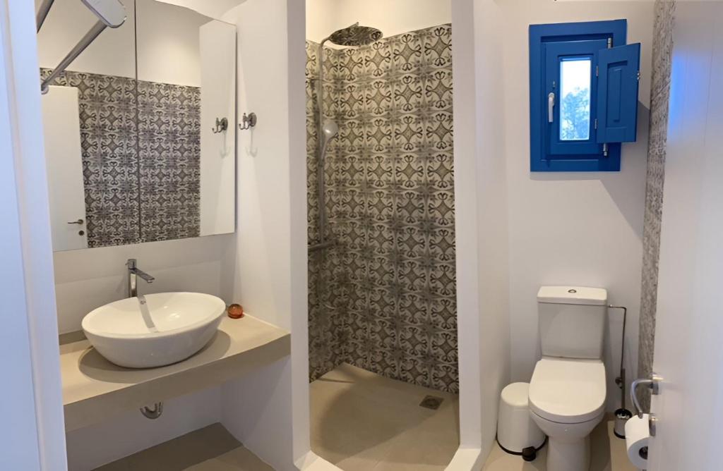 a bathroom with a sink and a toilet at Villa on the beach, Sarpakis Villa in Tzamaria