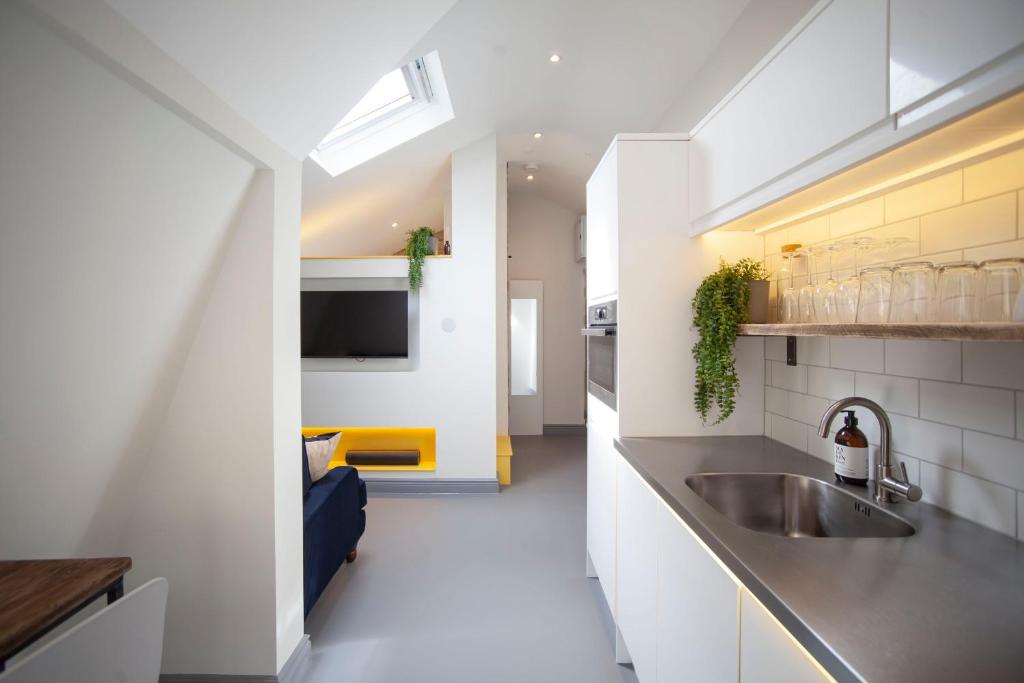 a kitchen with a sink and a counter top at higgihaus Apartment 6 Clare Street Aparthotel Central Location in Bristol