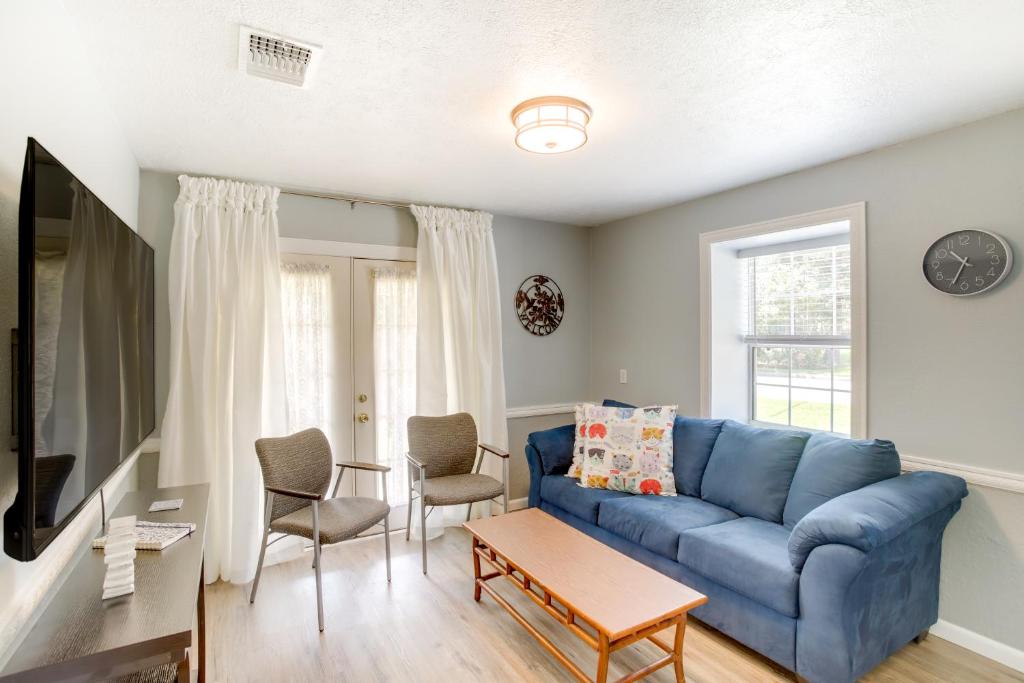 a living room with a blue couch and chairs at Cozy Shenandoah Home Less Than 2 Mi to The Woodlands Mall! in The Woodlands