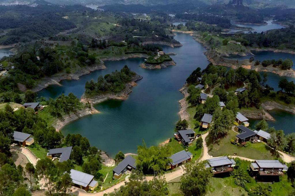 an aerial view of a river with homes at Luxé Cabañas in Guatapé