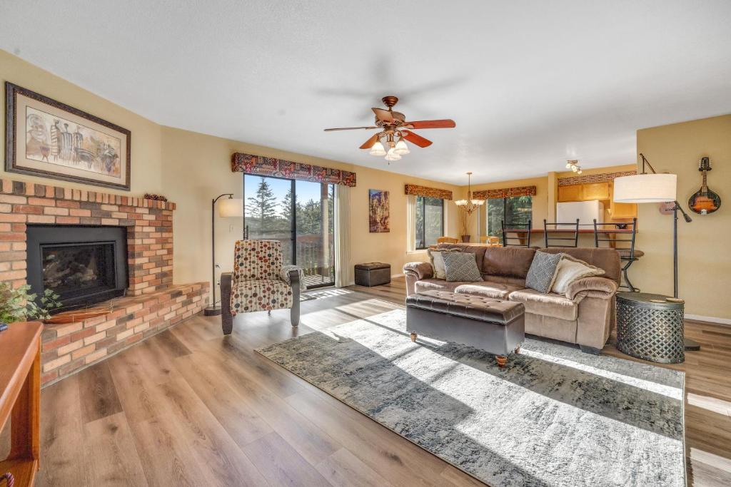 a living room with a couch and a fireplace at Charming Walnut Hills Condo in Flagstaff