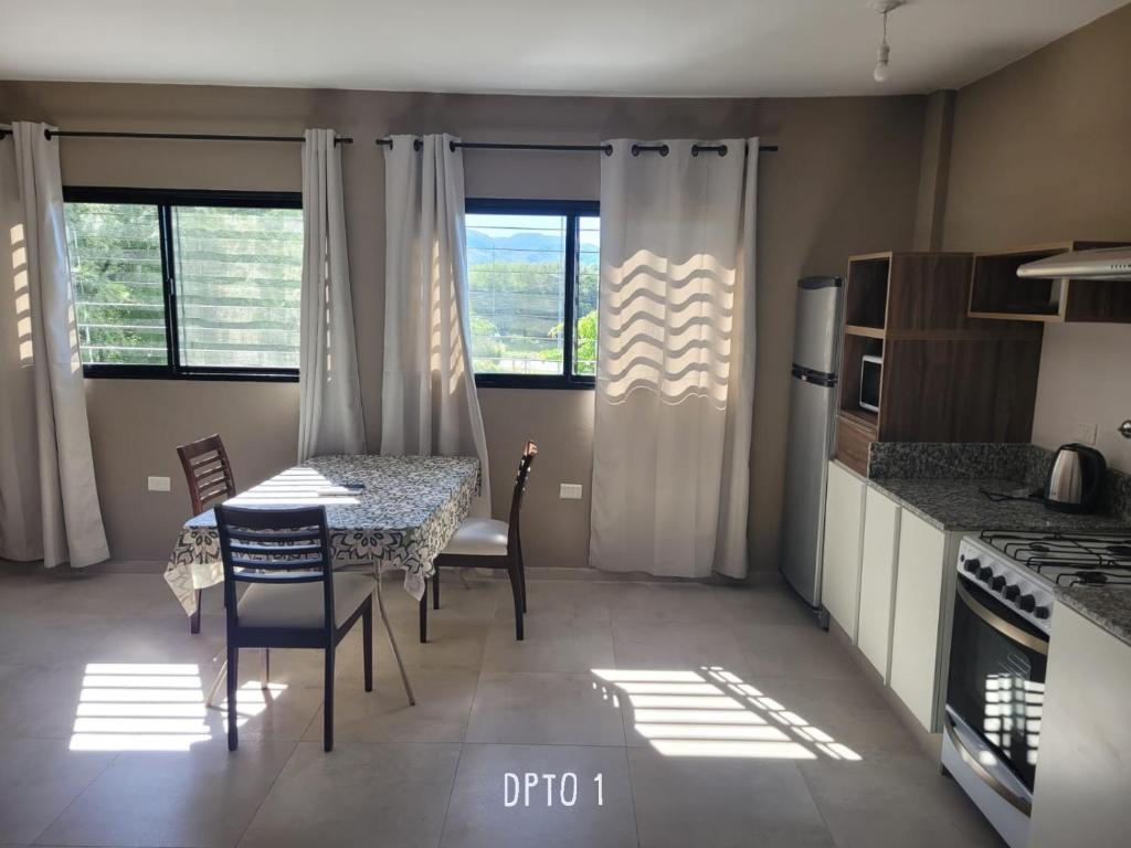 a kitchen with a table and chairs and some windows at ACHALAY, Alquileres temporarios Catamarca. DPTOS CENTRICOS HERMOSOS in San Fernando del Valle de Catamarca