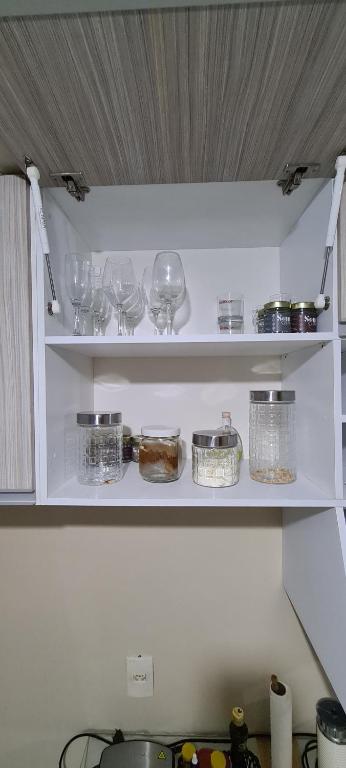 una mensola della cucina con bicchieri e stoviglie di Residencial Viver Ananindeua ad Ananindeua