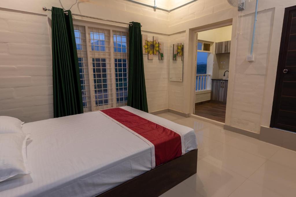 a bedroom with a bed and a large window at San Unik Homestay in Nilambūr