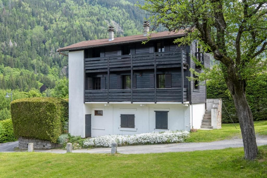 a house with a black and white exterior at Family chalet with sublime views of Mont Blanc in Chamonix