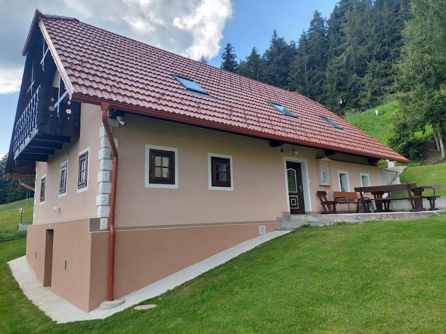 a small house with a picnic table in a yard at Sunflower House with SPA and Sauna in Vitanje