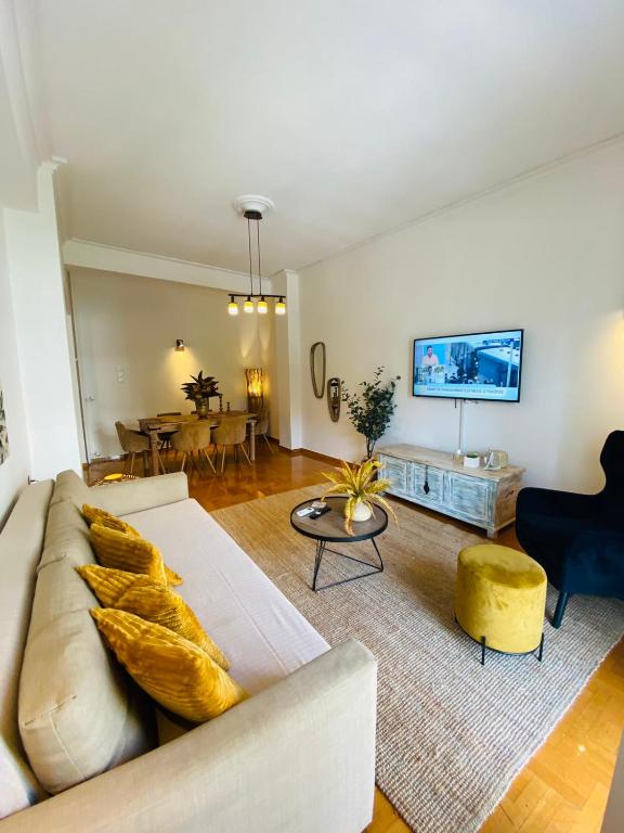 a living room with a couch and a table at 2 BD Apt in Koukaki 8’ away from Acropolis in Athens