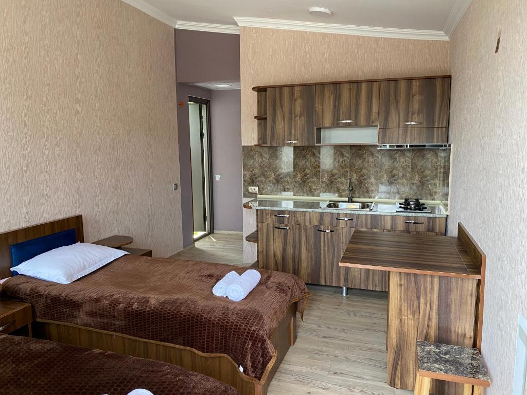 a hotel room with two beds and a kitchen at Sweet House In Rabati in Akhaltsikhe