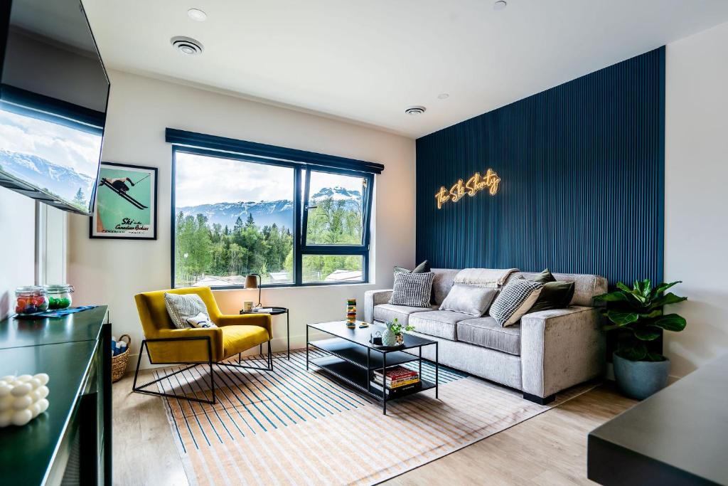 a living room with a couch and two chairs at The Ski Shanty by Revelstoke Vacations in Revelstoke