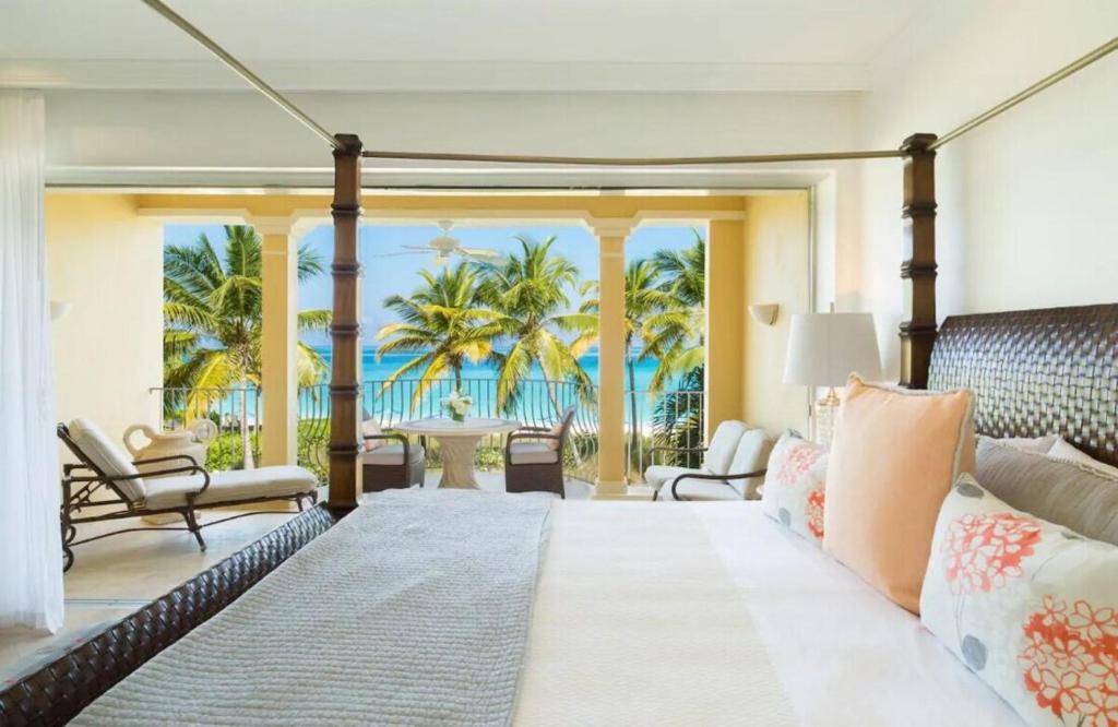 a bedroom with a bed and a view of the ocean at Villa Renaissance in Grace Bay