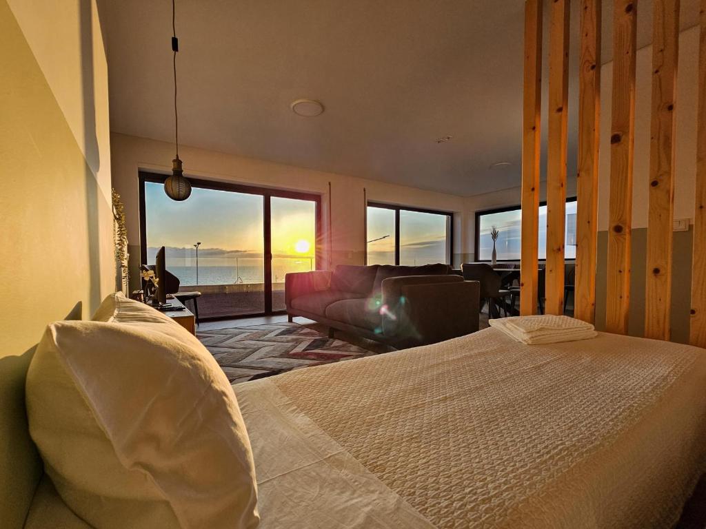 een slaapkamer met een bed en uitzicht op de oceaan bij CUSTÓDIO SEA HOME in Praia de Mira