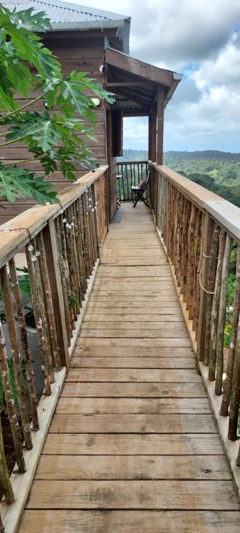 a wooden walkway leading to a cabin with a view at Bon Mange Organic Farm in Vieux Fort