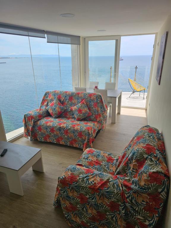 a living room with a couch and a chair at Casa del Mar in Almería