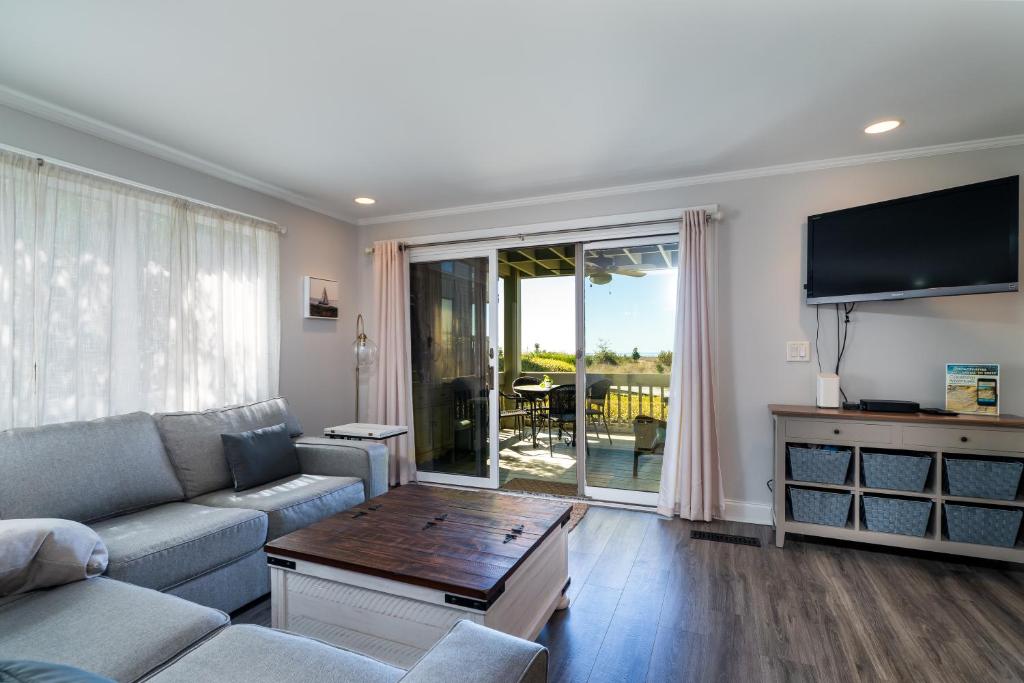 a living room with a couch and a table at 1385 Pelican Watch Villa in Seabrook Island