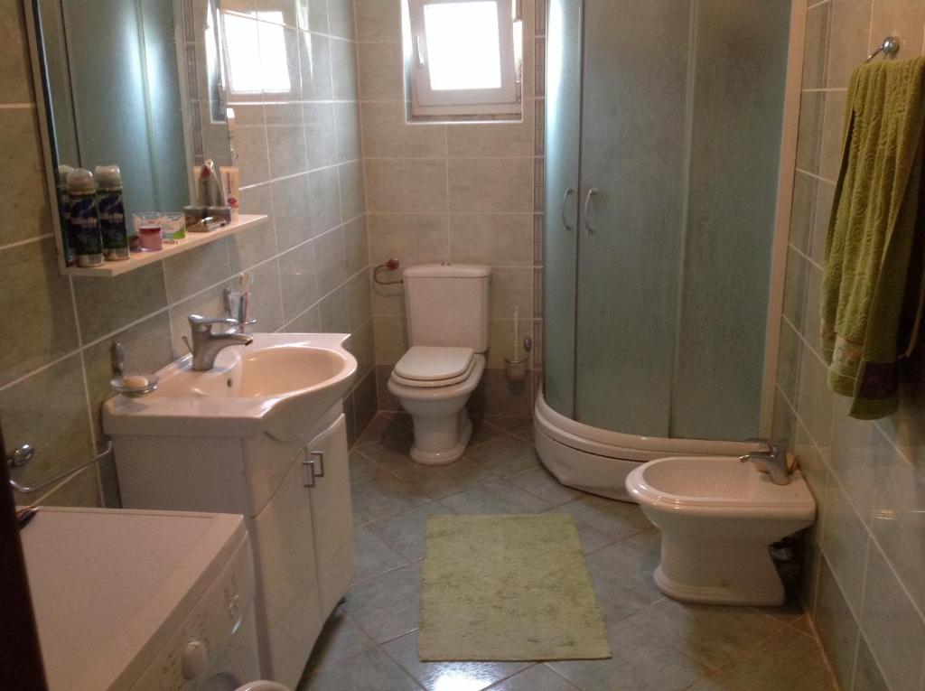a bathroom with a sink and a toilet and a shower at Guest House "Paradise" in Tivat