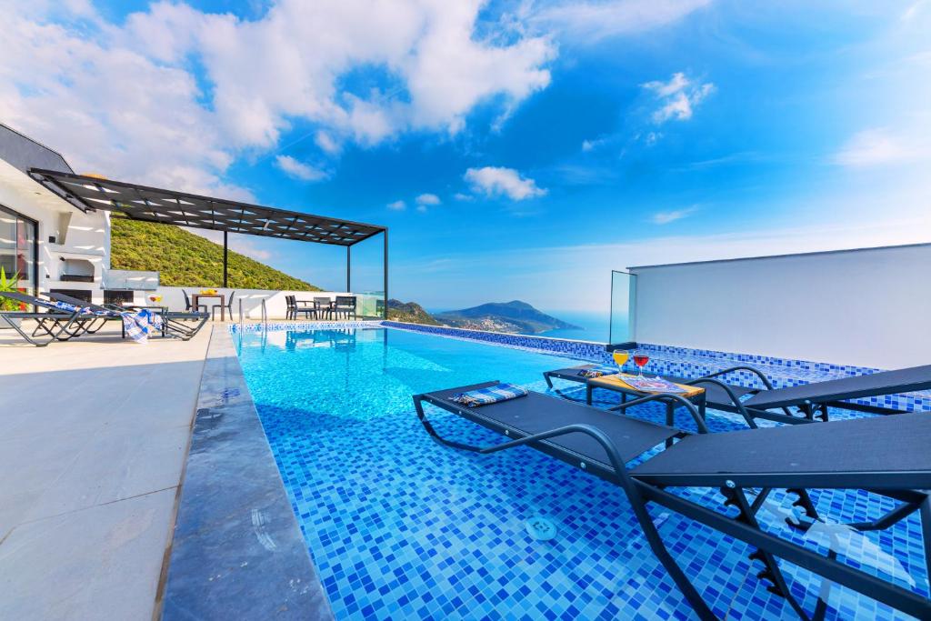 a swimming pool with a view of the ocean on a house at Villa Arya in Kas