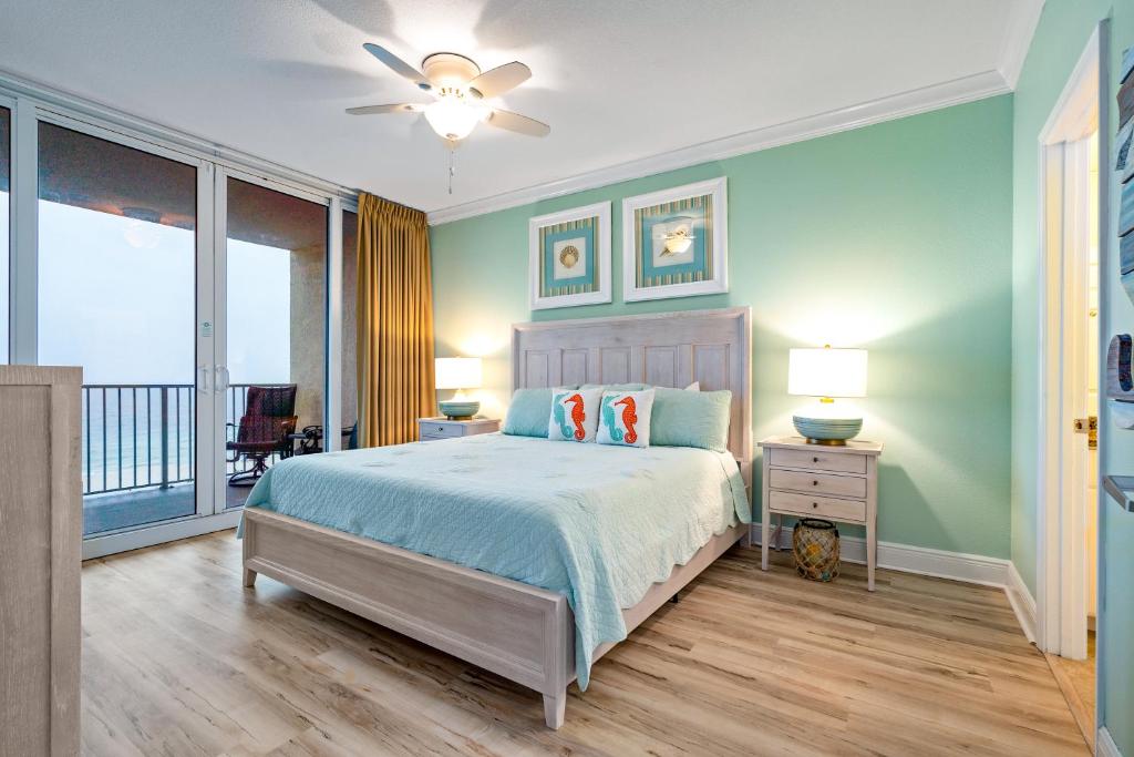 a bedroom with a bed and a balcony at San Carlos #407 in Gulf Shores
