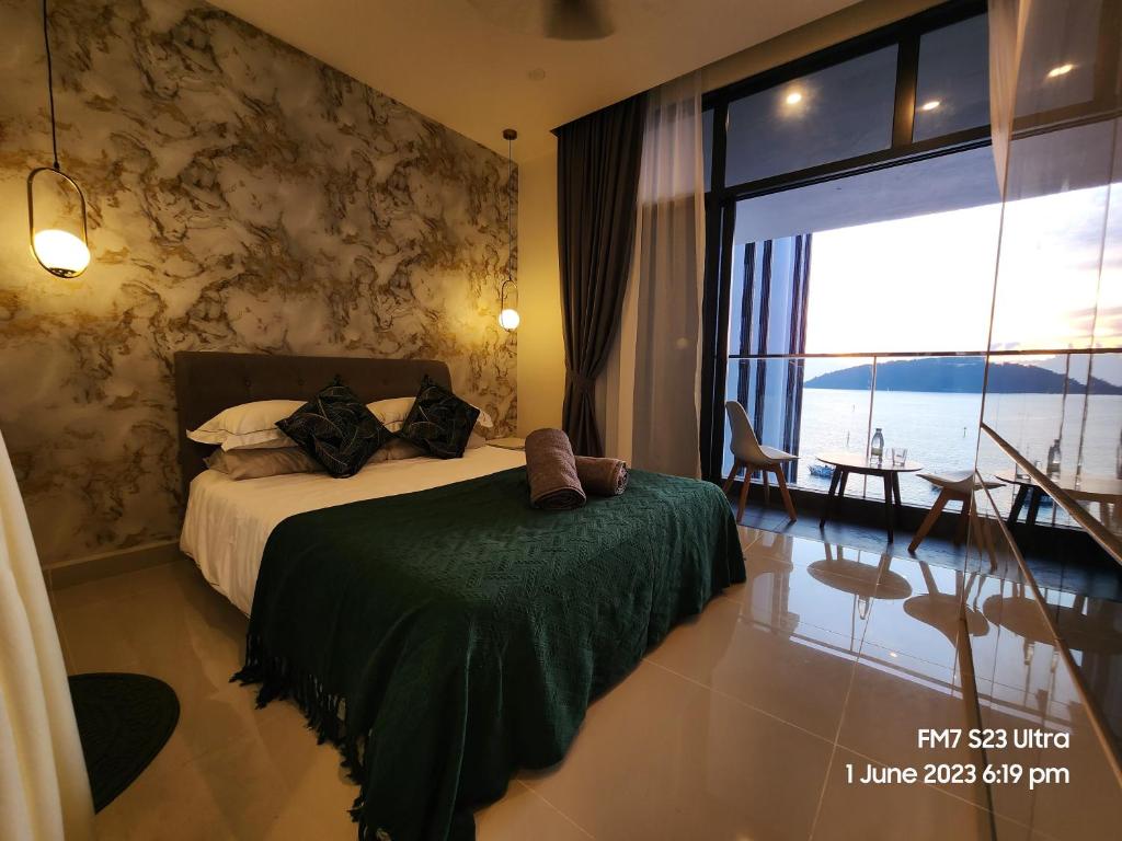 a bedroom with a bed and a large window at Seaview Luxury Suites at The Shore Kota Kinabalu in Kota Kinabalu