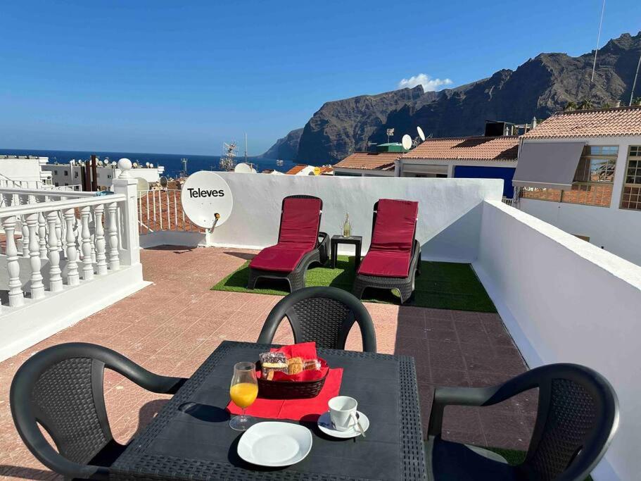 a table with a bowl of food on a balcony at Ocean View - BBQ by VV Canary Ocean Homes in Acantilado de los Gigantes