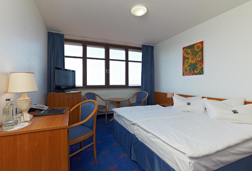Postel nebo postele na pokoji v ubytování Kim Hotel Dresden