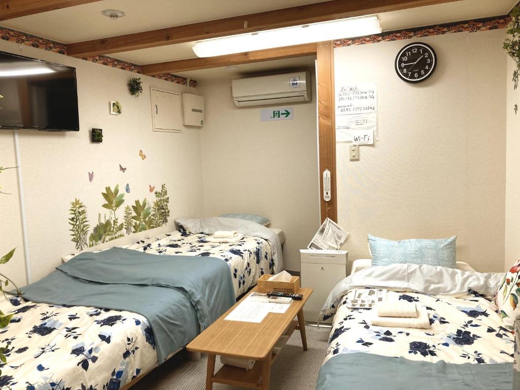 Postel nebo postele na pokoji v ubytování The Familiar Inn ー 旅館ホテル業