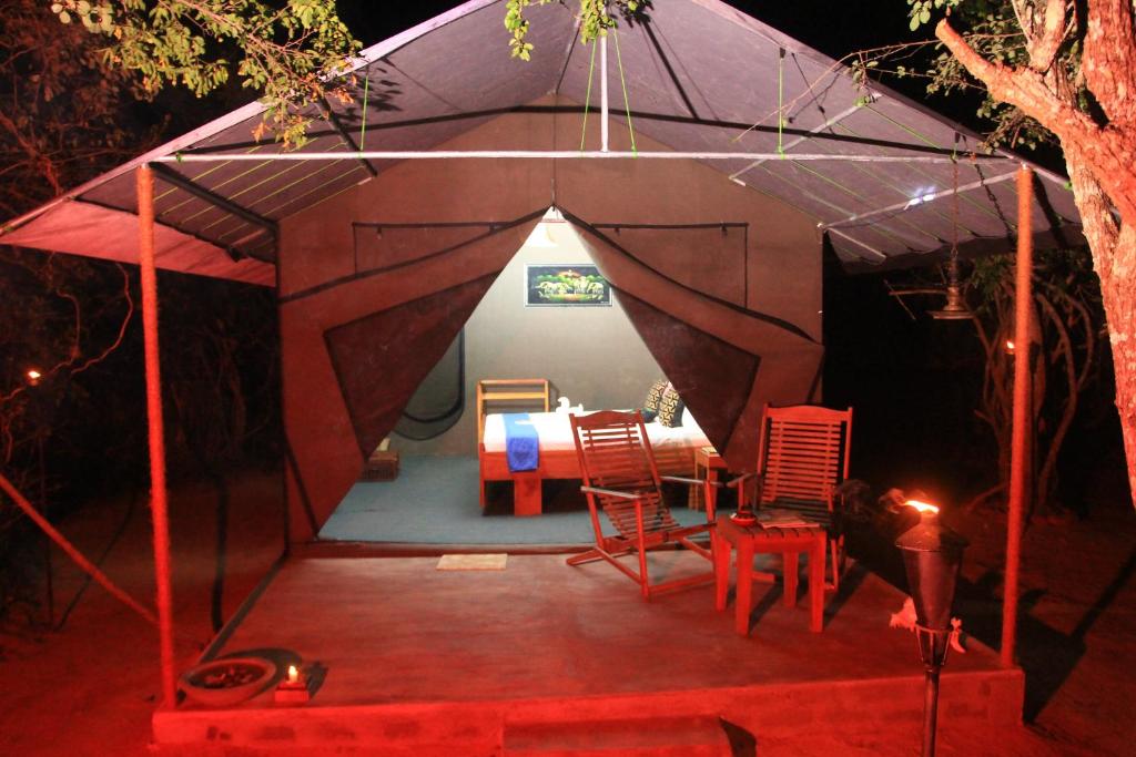 a tent with a table and chairs in it at The Campers Lodge Yala in Yala