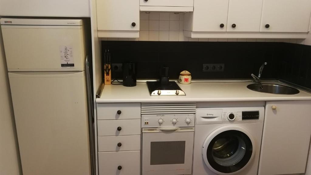 a kitchen with a sink and a washing machine at El pisito de Malasaña in Madrid