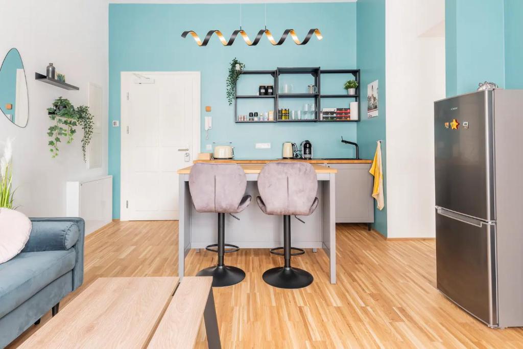 a kitchen with a counter and two stools at Cozy 2-Raumwohnung in Zentrumsnähe in Leipzig