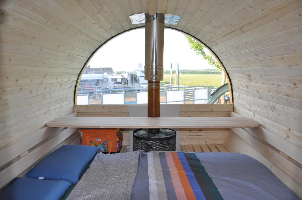 Habitación pequeña con cama y ventana en Campingfass im Ruheparadies, en Göda