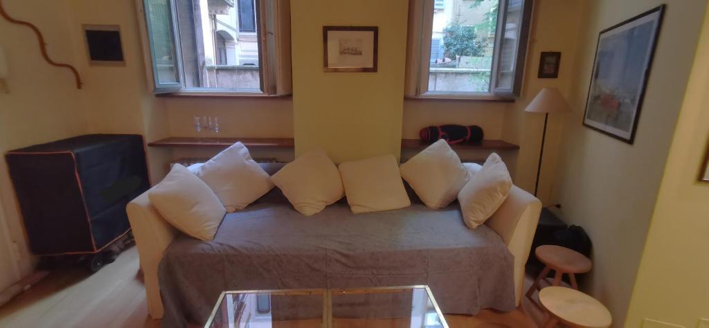 a living room with a couch with pillows and a table at Cenacolo Apartment in Milan