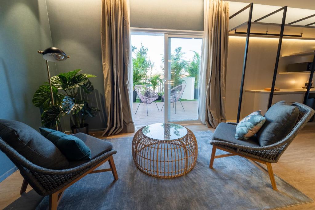 a living room with two chairs and a table at Hotel Taburiente S.C.Tenerife in Santa Cruz de Tenerife