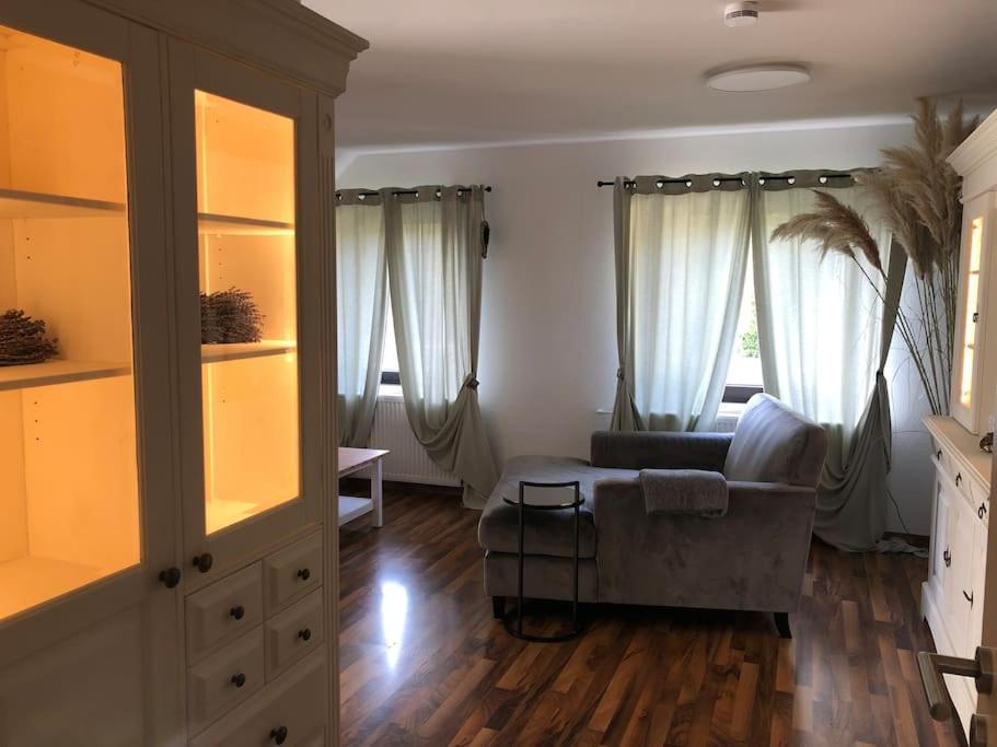 a living room with a couch and a chair at Ferienwohnung mit großer Dachterrasse in Bielefeld