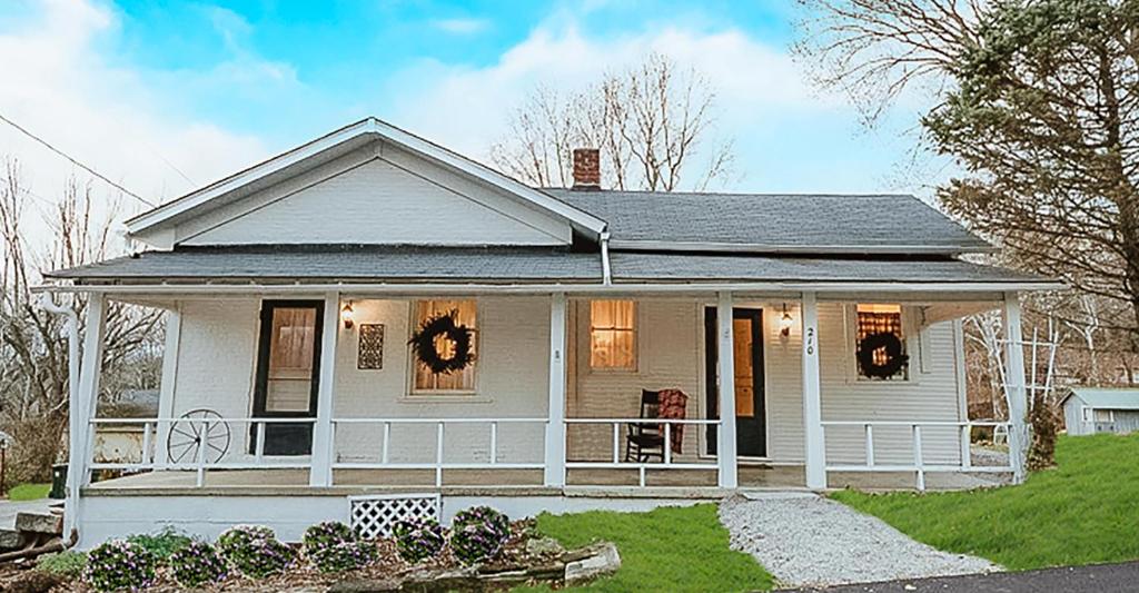 a white house with a porch with wreaths on it at 1840 Stagecoach in Nashville