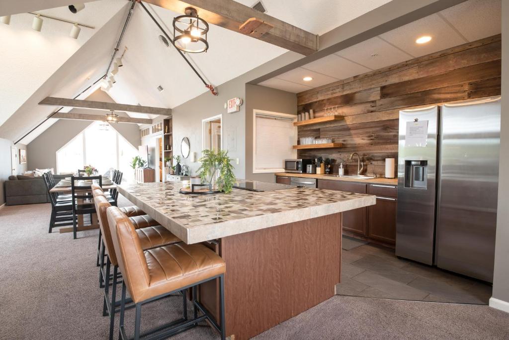 a kitchen with a large island with bar stools at The Loft By Moondance in Nashville