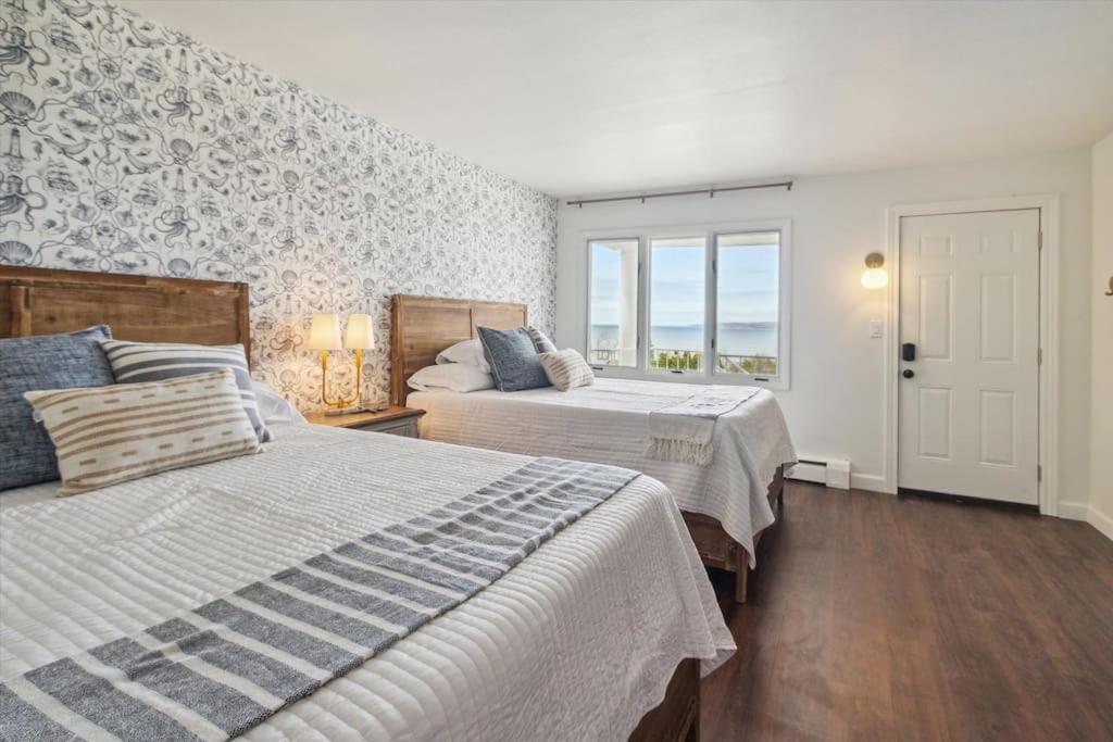 a bedroom with two beds and a window at Million Dollar Views of Petoskey Bay DTPetoskey in Petoskey