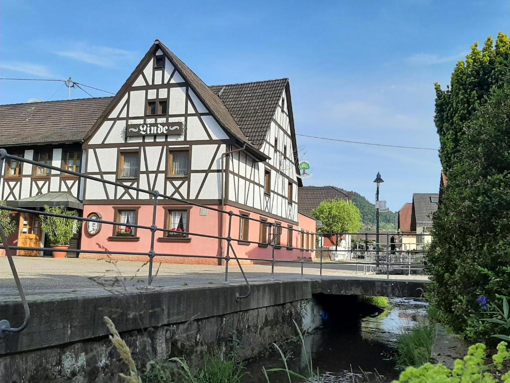 a building next to a river with a bridge at Linde Diersburg Stammhaus in Diersburg