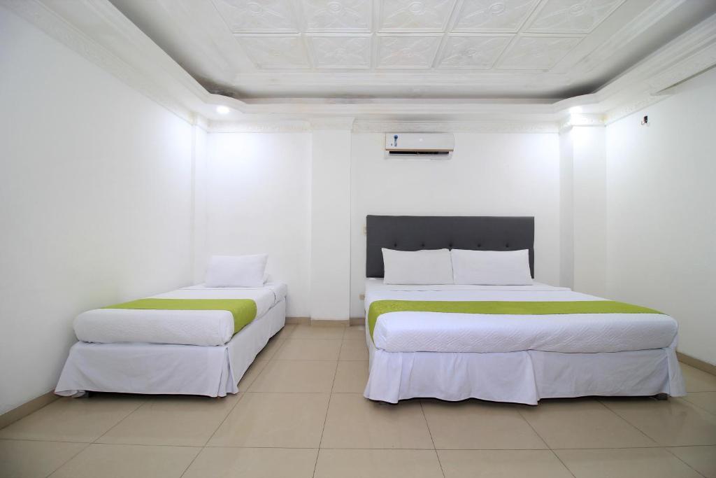 Uma cama ou camas num quarto em Hotel Abi Inn By GEH Suites