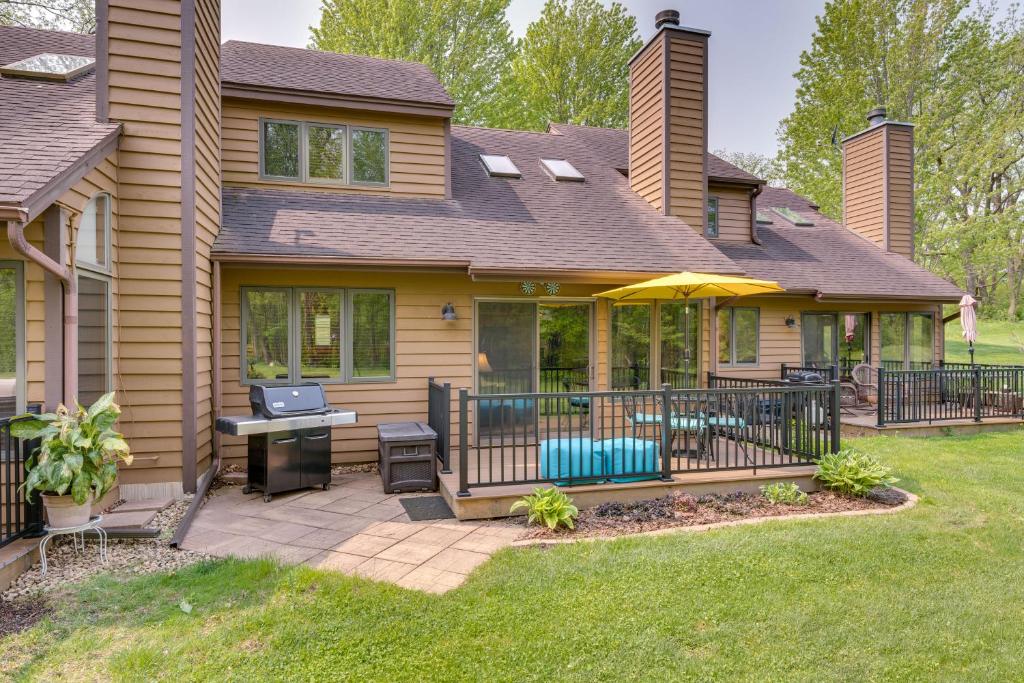 a house with a patio with an umbrella at Updated Retreat with Golf Course and Wildlife Views! in Galena
