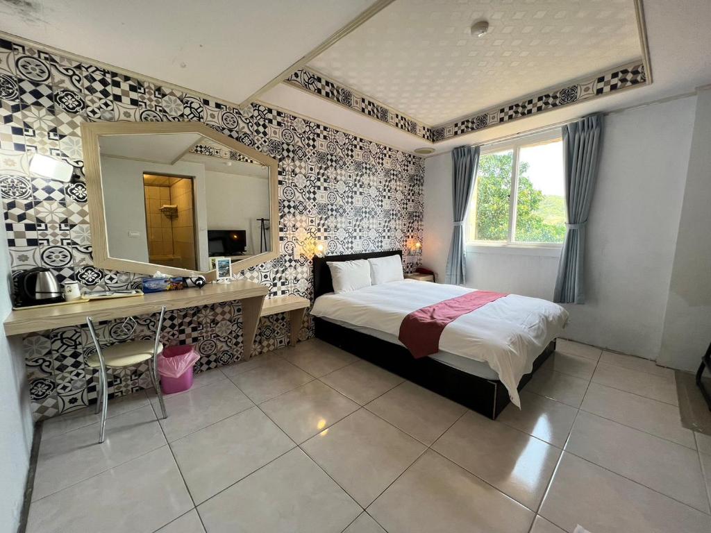 Postel nebo postele na pokoji v ubytování Dajenshan Hotel